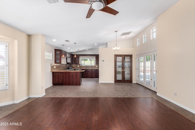 kitchen featuring ceiling fan with notable chandelier, dark wood-style flooring, visible vents, open floor plan, and french doors