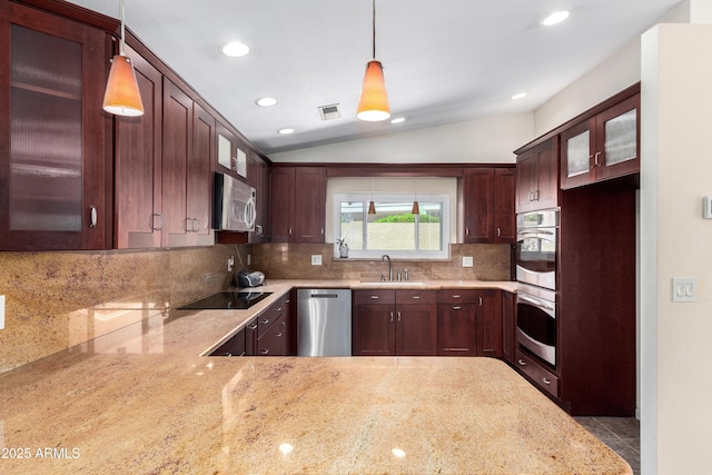 kitchen featuring vaulted ceiling, glass insert cabinets, appliances with stainless steel finishes, and a sink