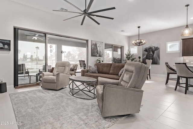 living room with a notable chandelier and light tile patterned floors