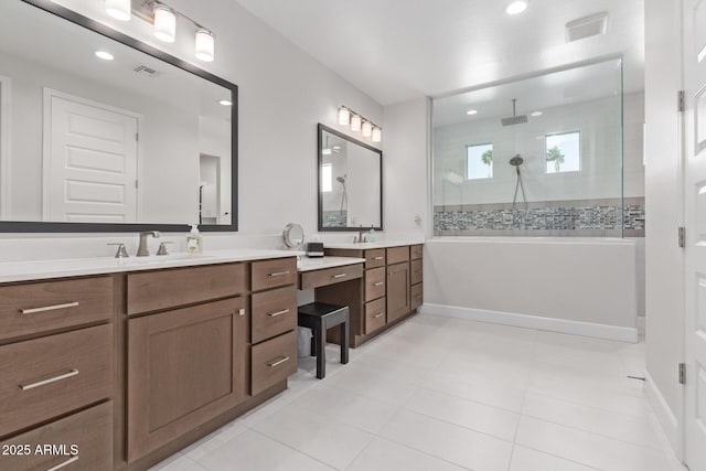 bathroom featuring tile patterned flooring, vanity, and tiled shower