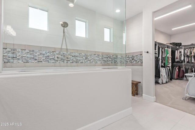 bathroom with a shower and tile patterned flooring