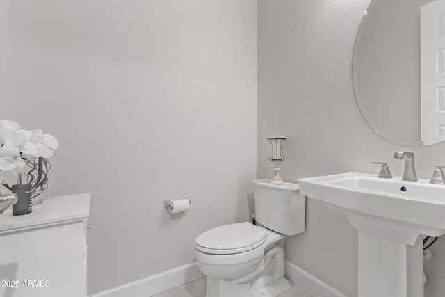 bathroom featuring tile patterned floors, toilet, and sink