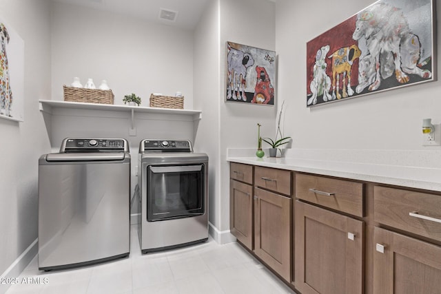 laundry area with cabinets and separate washer and dryer