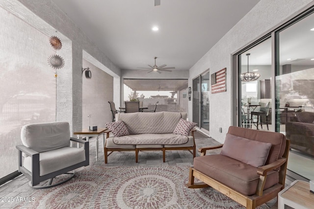 interior space featuring plenty of natural light and ceiling fan with notable chandelier