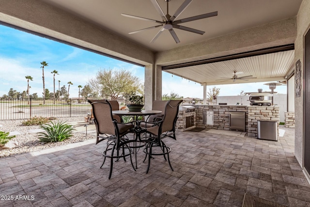 view of patio / terrace with an outdoor kitchen and ceiling fan