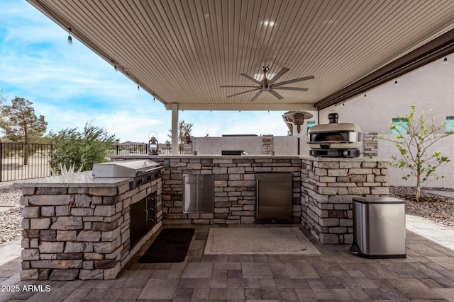 view of patio / terrace with an outdoor kitchen, ceiling fan, and area for grilling