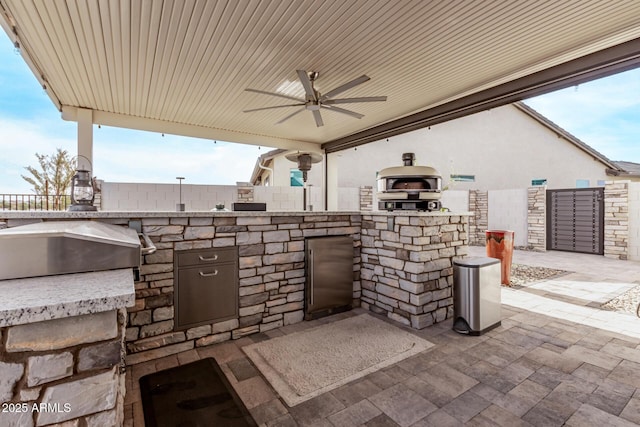 view of patio / terrace featuring an outdoor kitchen, ceiling fan, and grilling area