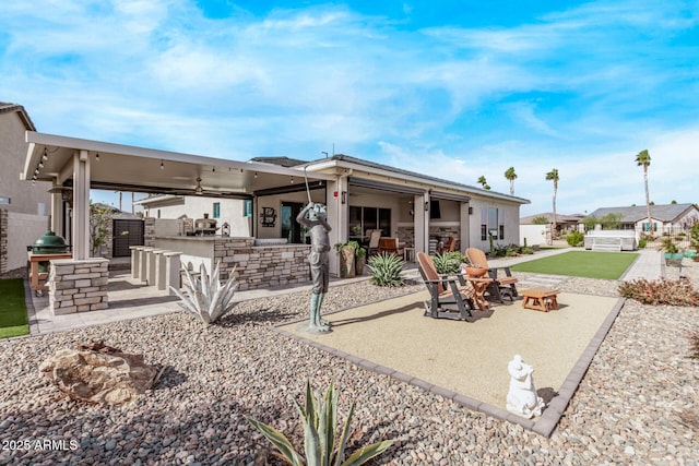 back of house featuring ceiling fan, exterior bar, and a patio