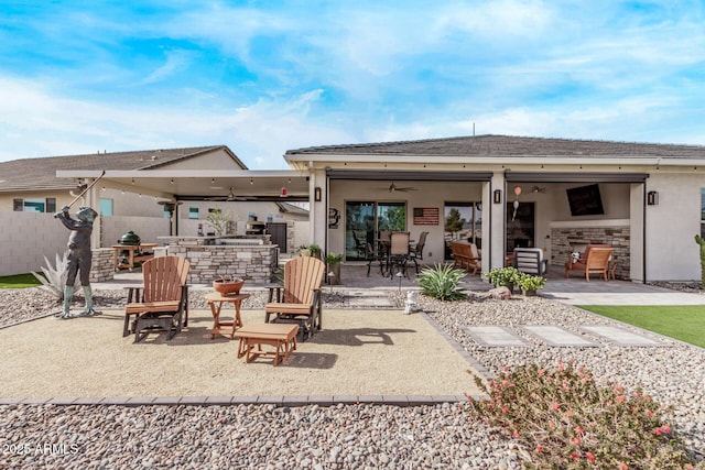 rear view of house featuring a patio area, ceiling fan, and exterior kitchen