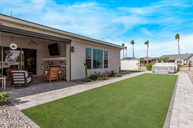 view of yard featuring ceiling fan and a patio area