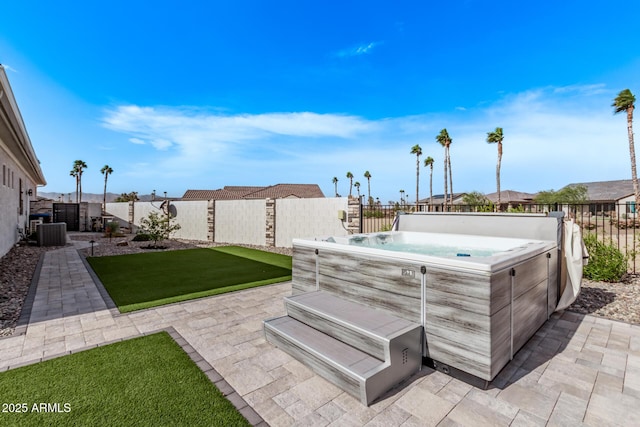 view of patio with cooling unit and a hot tub