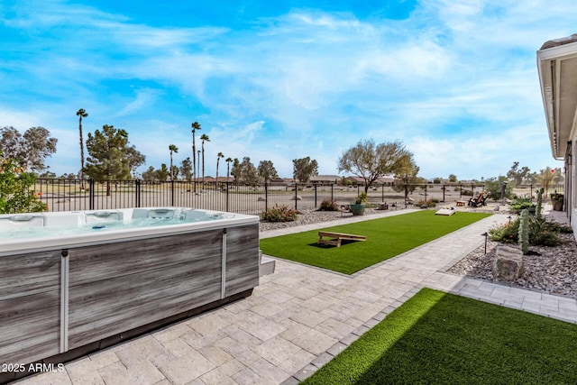 view of patio / terrace with a hot tub