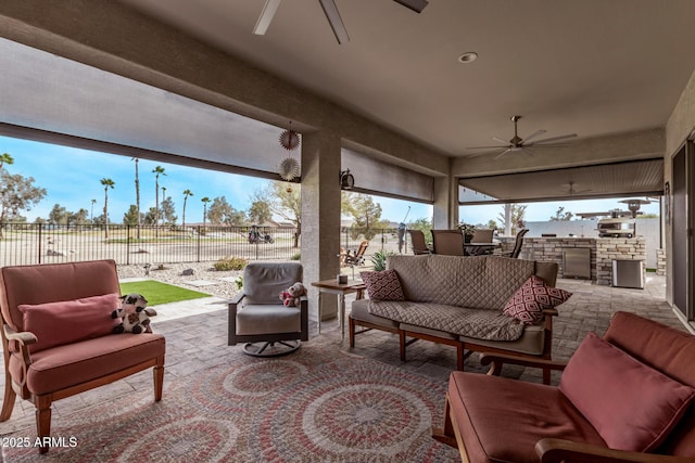 view of patio with area for grilling, an outdoor living space, and ceiling fan