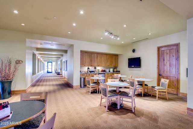 dining space with light colored carpet