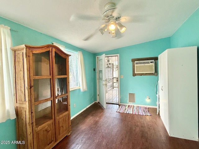 9495 E Marilyn Ln, Dewey, AZ 86327 - interior space with a wall mounted air conditioner, a ceiling fan, dark wood-style floors, and baseboards