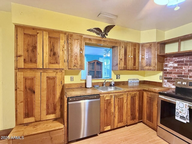 9495 E Marilyn Ln, Dewey, AZ 86327 - kitchen featuring stainless steel appliances, a sink, brown cabinets, and dark countertops