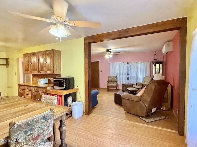 9495 E Marilyn Ln, Dewey, AZ 86327 - dining area featuring ceiling fan, an AC wall unit, and light wood-type flooring