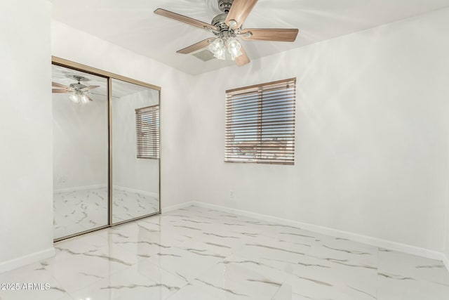 unfurnished bedroom featuring ceiling fan and a closet