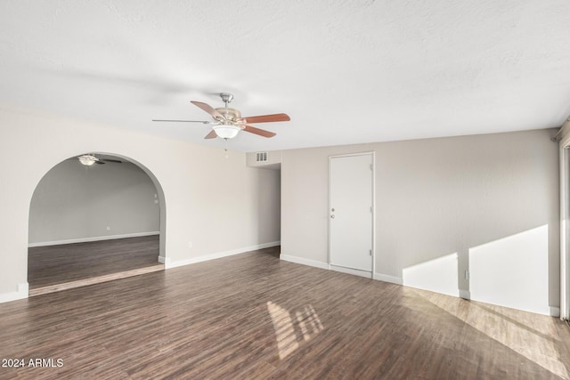 spare room with a textured ceiling, dark hardwood / wood-style floors, and ceiling fan