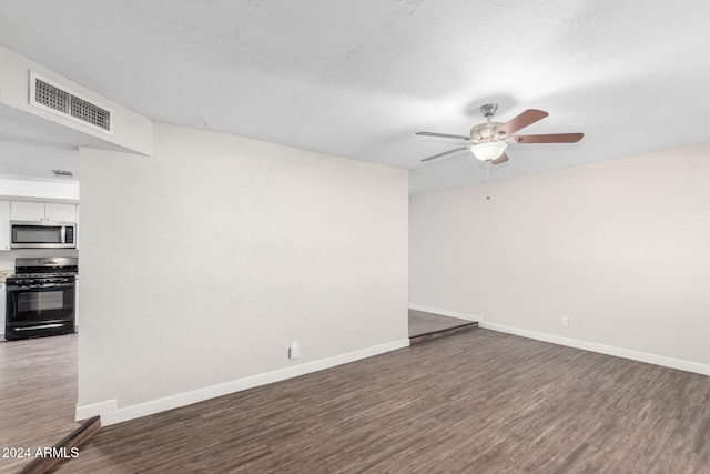 spare room featuring ceiling fan and dark wood-type flooring