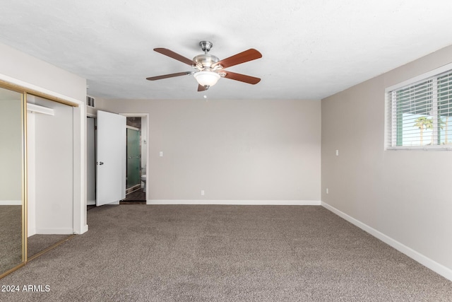 unfurnished bedroom with carpet, ceiling fan, and a closet