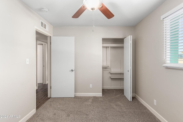 unfurnished bedroom with ceiling fan, a closet, and light carpet