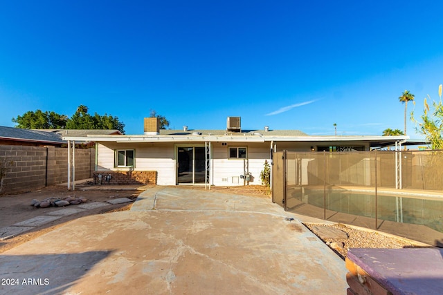 back of house with a patio area and central AC