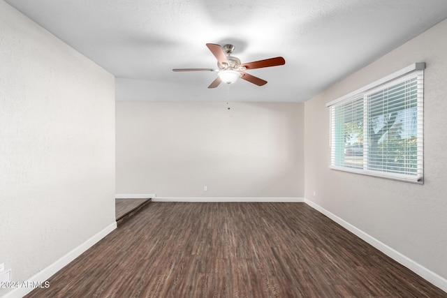 spare room featuring a textured ceiling, dark hardwood / wood-style flooring, and ceiling fan