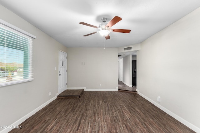 spare room featuring dark hardwood / wood-style flooring and ceiling fan