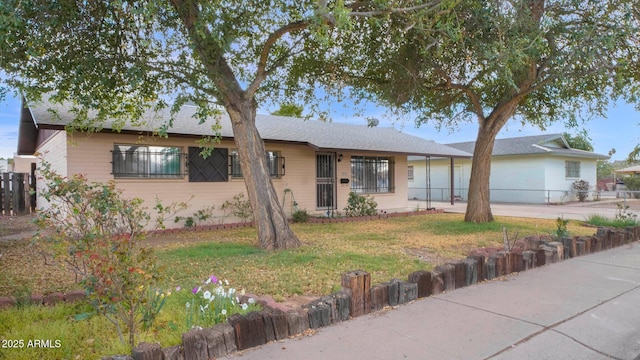 single story home with fence and a front lawn