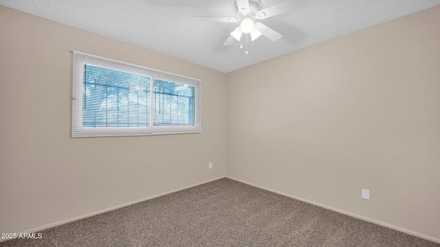 carpeted spare room with a textured ceiling, ceiling fan, and baseboards