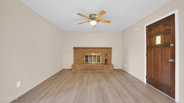 unfurnished living room with ceiling fan, a fireplace, and wood finished floors