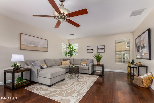 living room featuring ceiling fan and dark hardwood / wood-style flooring