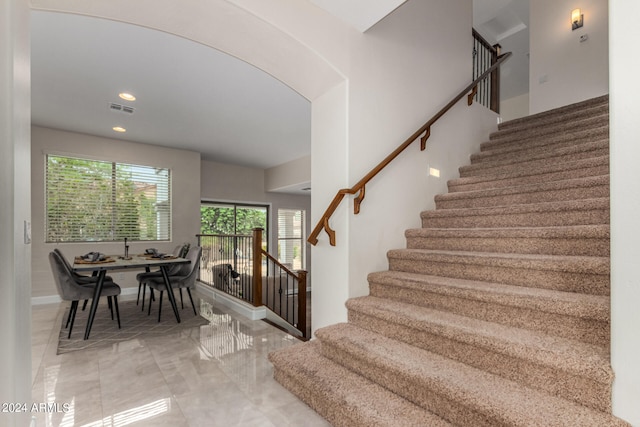 stairs with tile patterned flooring