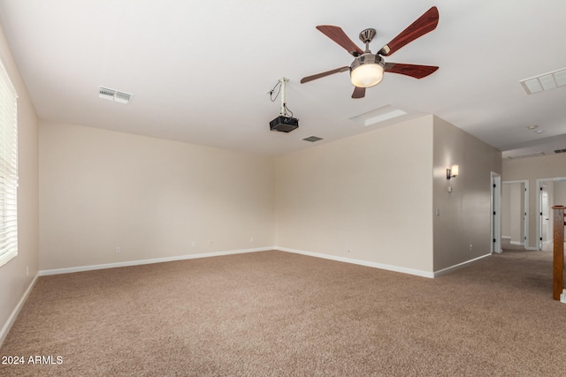 spare room with ceiling fan and carpet