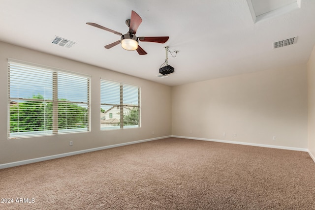 empty room with ceiling fan and carpet floors