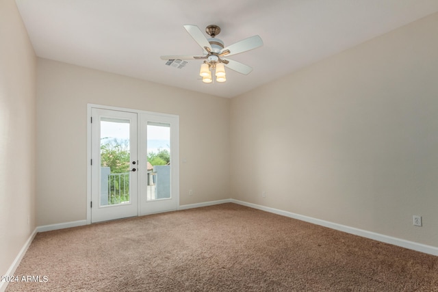 spare room featuring light colored carpet, french doors, and ceiling fan