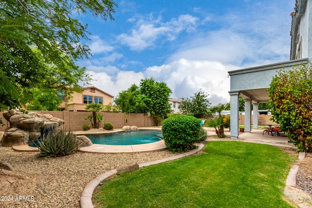 view of pool featuring a patio area and a yard