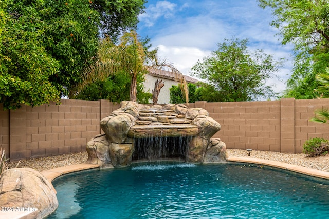 view of pool with pool water feature