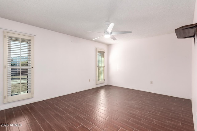 unfurnished room with ceiling fan and a textured ceiling