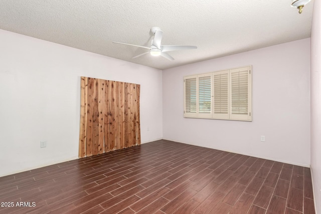 unfurnished room with ceiling fan, dark hardwood / wood-style floors, and a textured ceiling