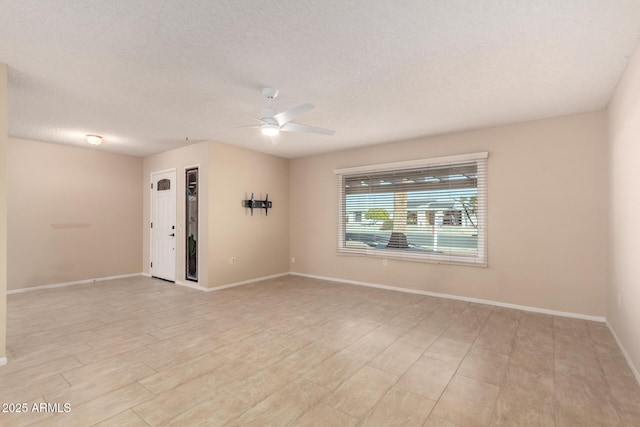 unfurnished room featuring a textured ceiling and ceiling fan