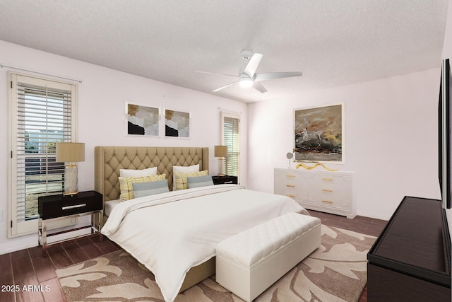 bedroom with ceiling fan and a textured ceiling