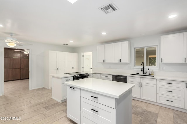 kitchen with sink, a center island, and white cabinets