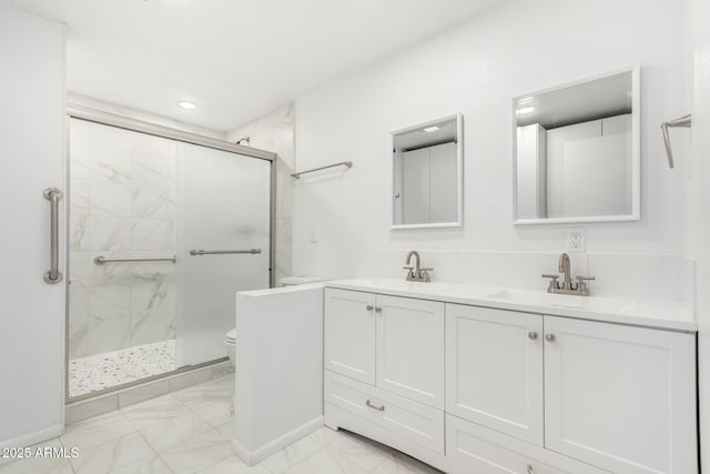 bathroom with vanity, toilet, and walk in shower