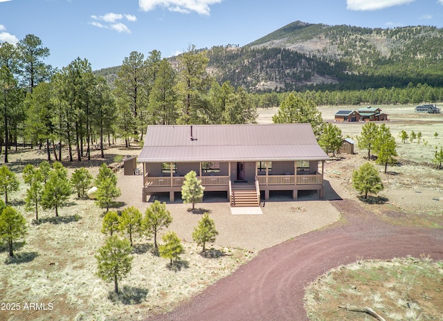 17622 Crowley Trl, Flagstaff, AZ 86001 - view of front of home with a porch, metal roof, and a mountain view