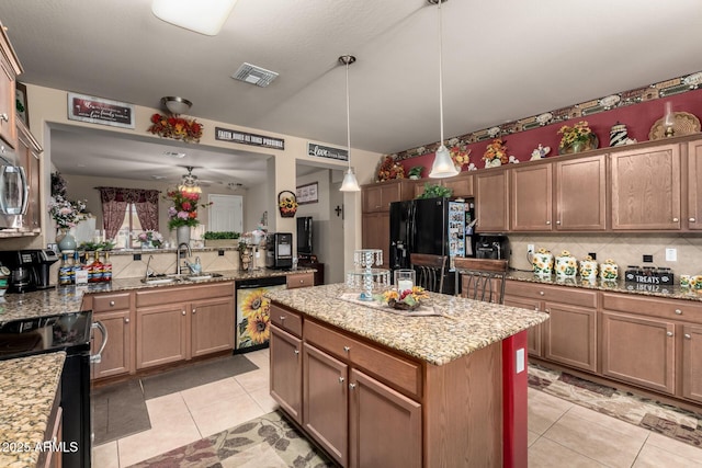 7015 W Melody Dr, Laveen, AZ 85339 - kitchen featuring black appliances, a sink, backsplash, light tile patterned floors, and light stone countertops