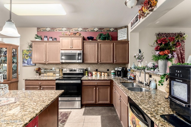 7015 W Melody Dr, Laveen, AZ 85339 - kitchen with appliances with stainless steel finishes, a sink, backsplash, light tile patterned floors, and hanging light fixtures