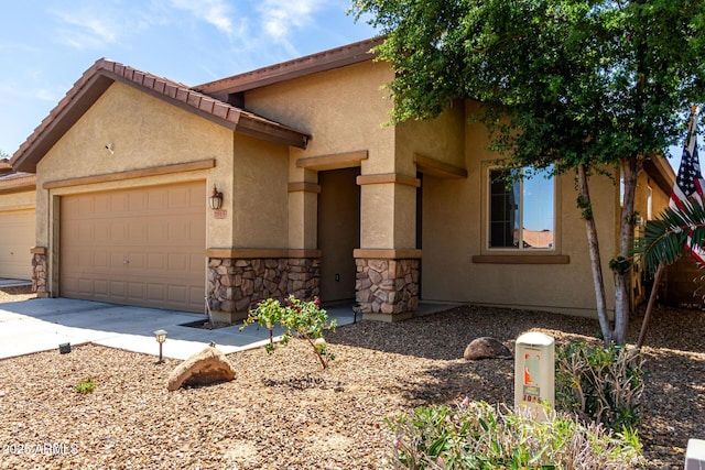 7015 W Melody Dr, Laveen, AZ 85339 - view of front of property featuring an attached garage, driveway, stone siding, and stucco siding