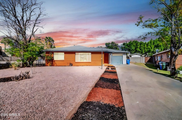 7039 N 15th St, Phoenix, AZ 85020 - view of front of home featuring an attached garage, concrete driveway, and fence